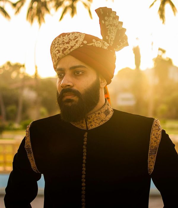 A person looking refreshed and energized outdoors at sunrise.