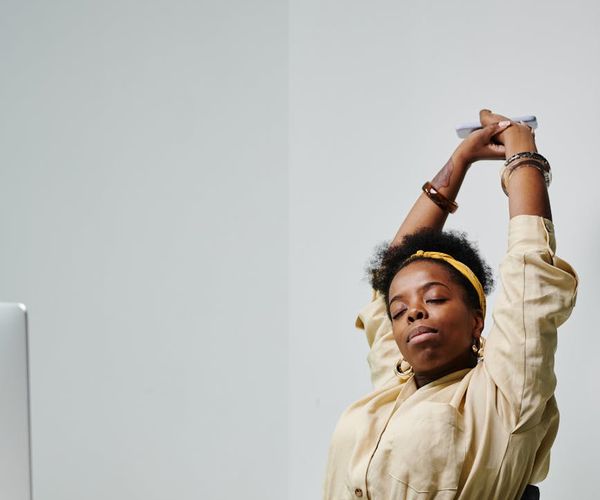 Person taking a short stretching break at an office desk.